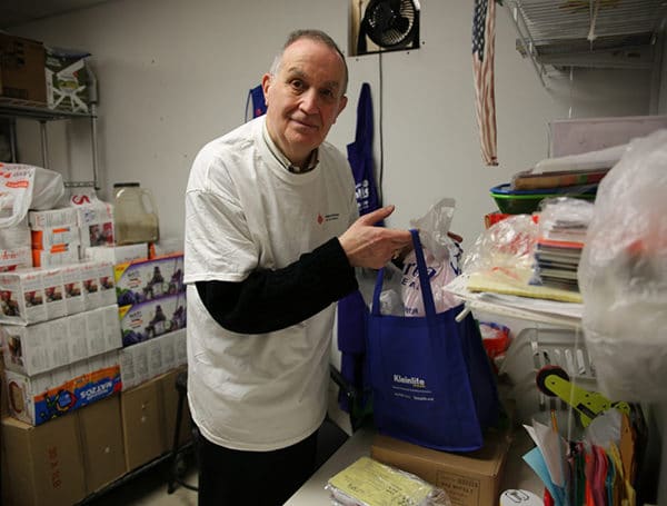 Jack Belitsky prepares food packages for delivery to vulnerable community members