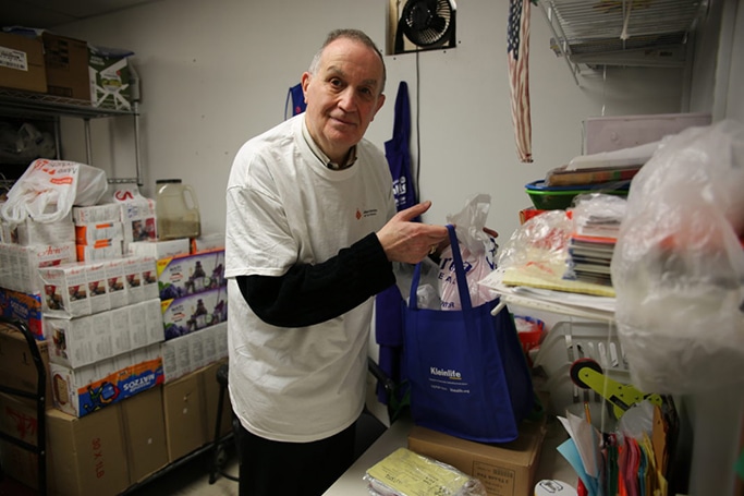 Jack Belitsky prepares food packages for delivery to vulnerable community members